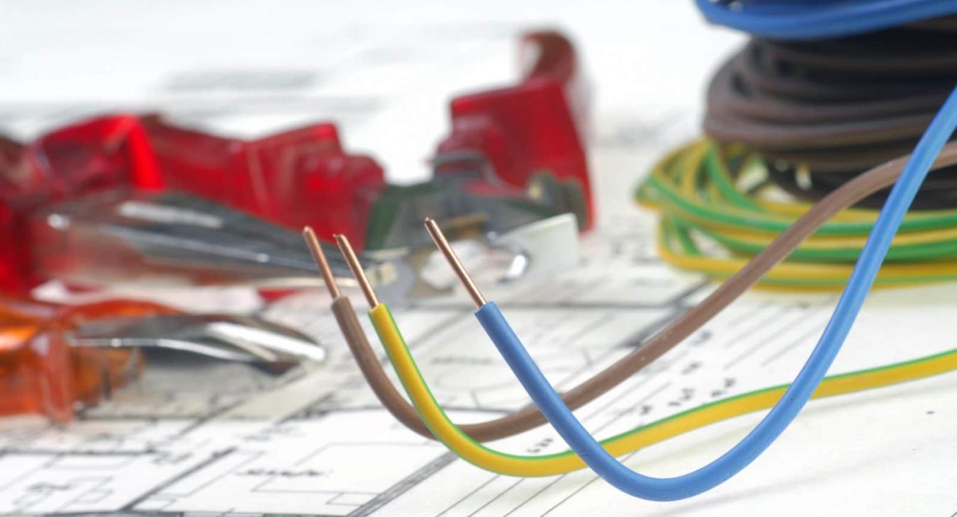 Wiring and electrical tools on office blueprint